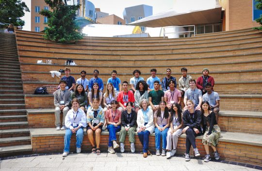 Group of high school students posing for a group photo with MIT President Emerita Susan Hockfield