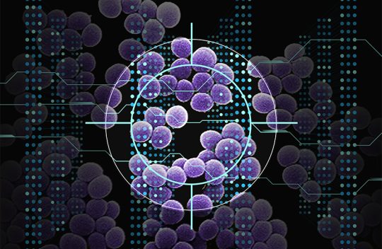 Image of a reticle aiming at a group of purple microscopic cells against a background of glowing dots.